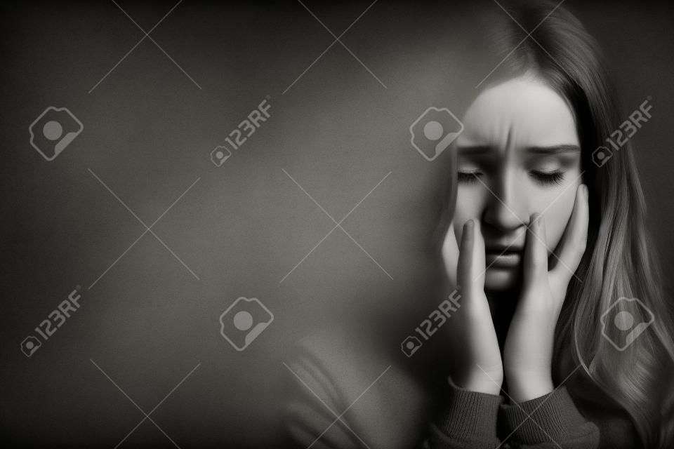 Zwart-wit beeld van bange mooie jonge roodharige vrouw met posttraumatische stress stoornis met slaapproblemen