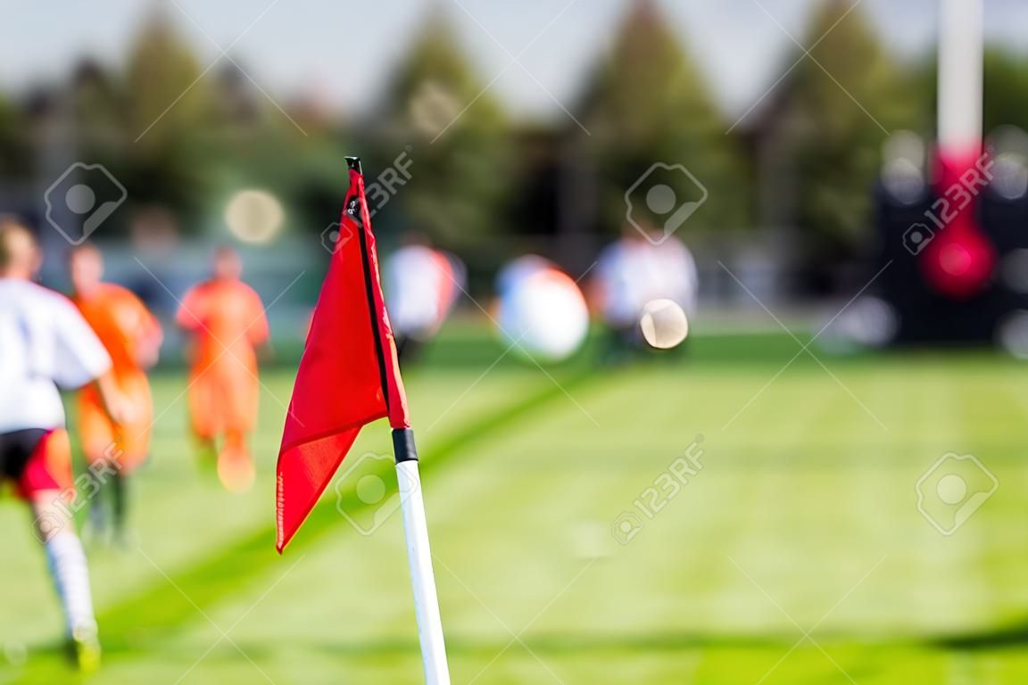 Shallow depth of field shot of group of male soccer players playing amateur soccer match on sunny summer day on simple sports venue in Denmark.