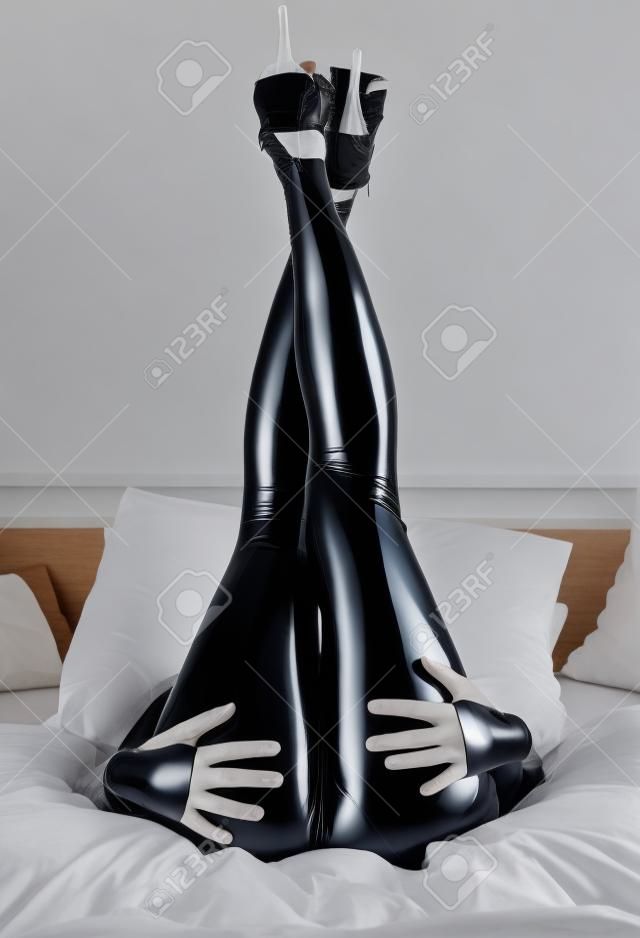 woman in latex in bed