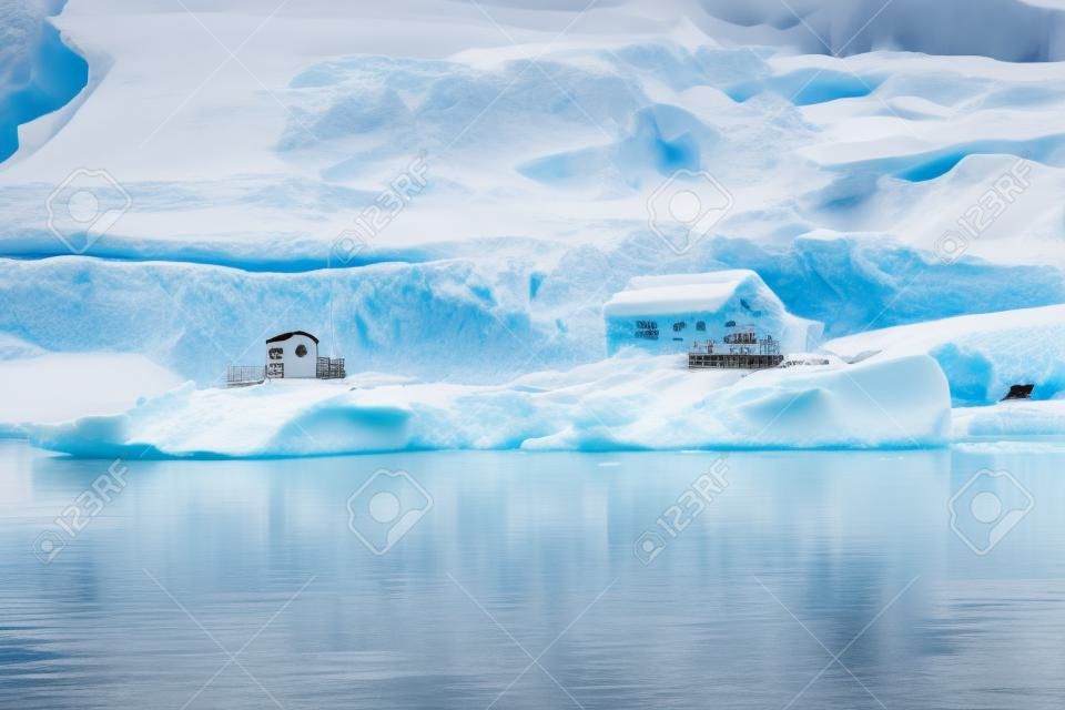 Snowing Argentine Almirante Brown Station Blue Glacier Mountain Paradise Harbor Bay Antarctic Peninsula Antarctica.  Glacier ice blue because air squeezed out of snow.