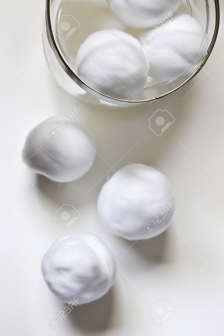 Cotton balls out of jar isolated