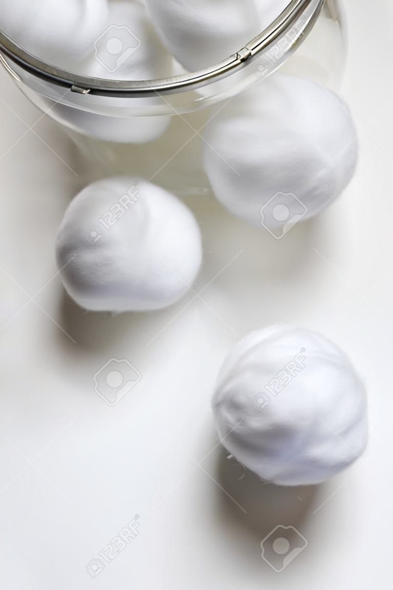 Cotton balls out of jar isolated