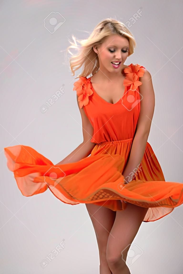 Beautiful woman holding her skirt. Lifted by the wind