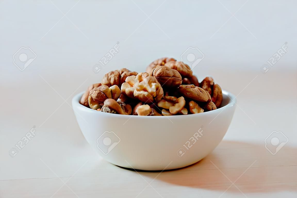 Walnuts kernel in a ceramic white bowl.