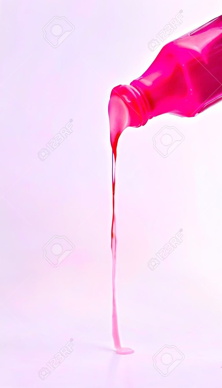 Bottle of pink nail polish, enamel smear