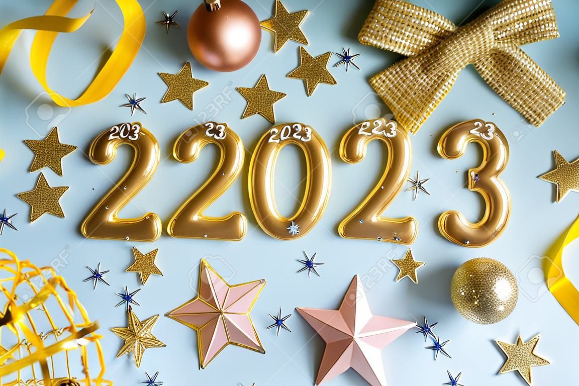 New year 2023 celebration greeting card background Gold numbers 2023 with golden party decoration, stars confetti on blue background. Flat lay Merry Christmas, Noel happy New Year holidays banner