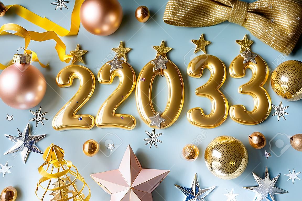 New year 2023 celebration greeting card background Gold numbers 2023 with golden party decoration, stars confetti on blue background. Flat lay Merry Christmas, Noel happy New Year holidays banner