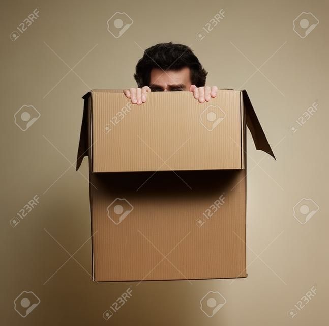 Man hiding in a box