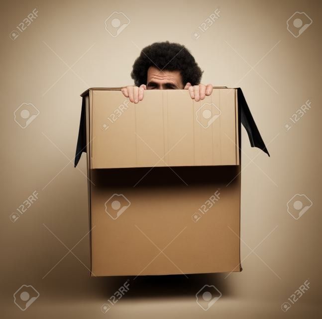 Man hiding in a box