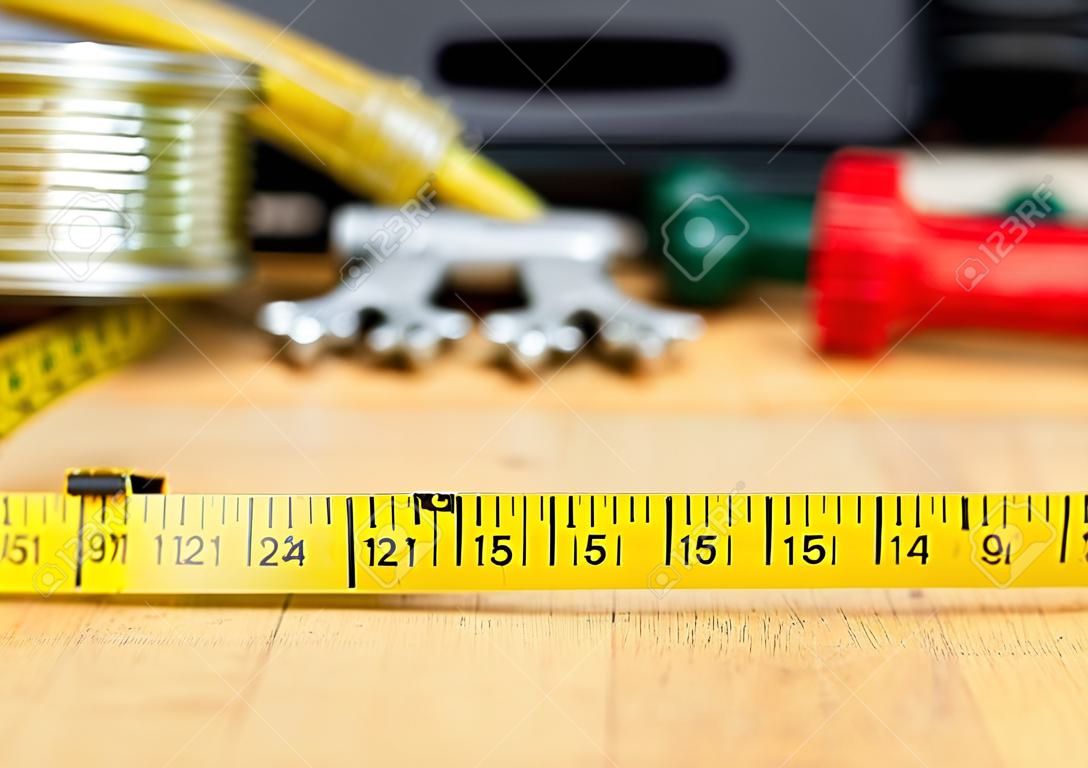 measuring tape with set of work tools background