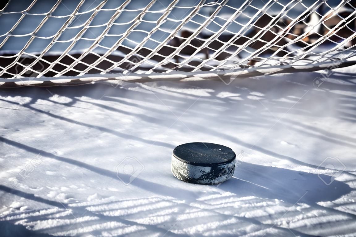 Hockey net with puck in goal