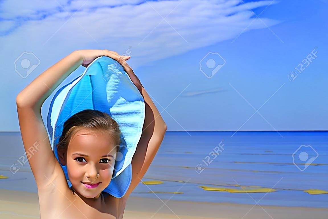 Preteen girl on a beach on blue background