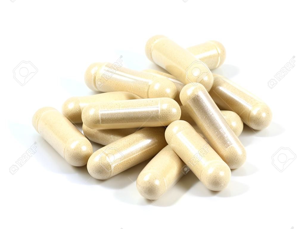 Drug capsule pills with beige medication in pile, isolated