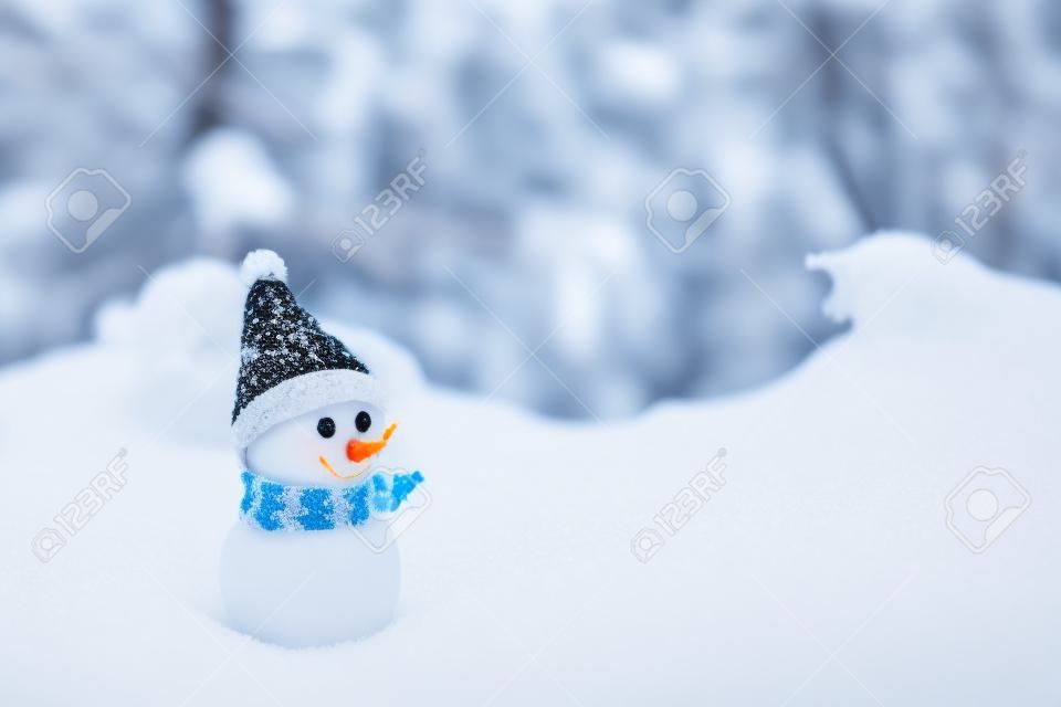 little snowman on soft snow in the forest in winter