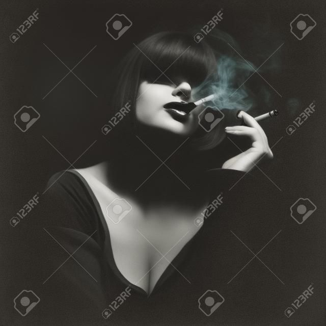 Young woman smoking a cigarette. Monochrome portrait