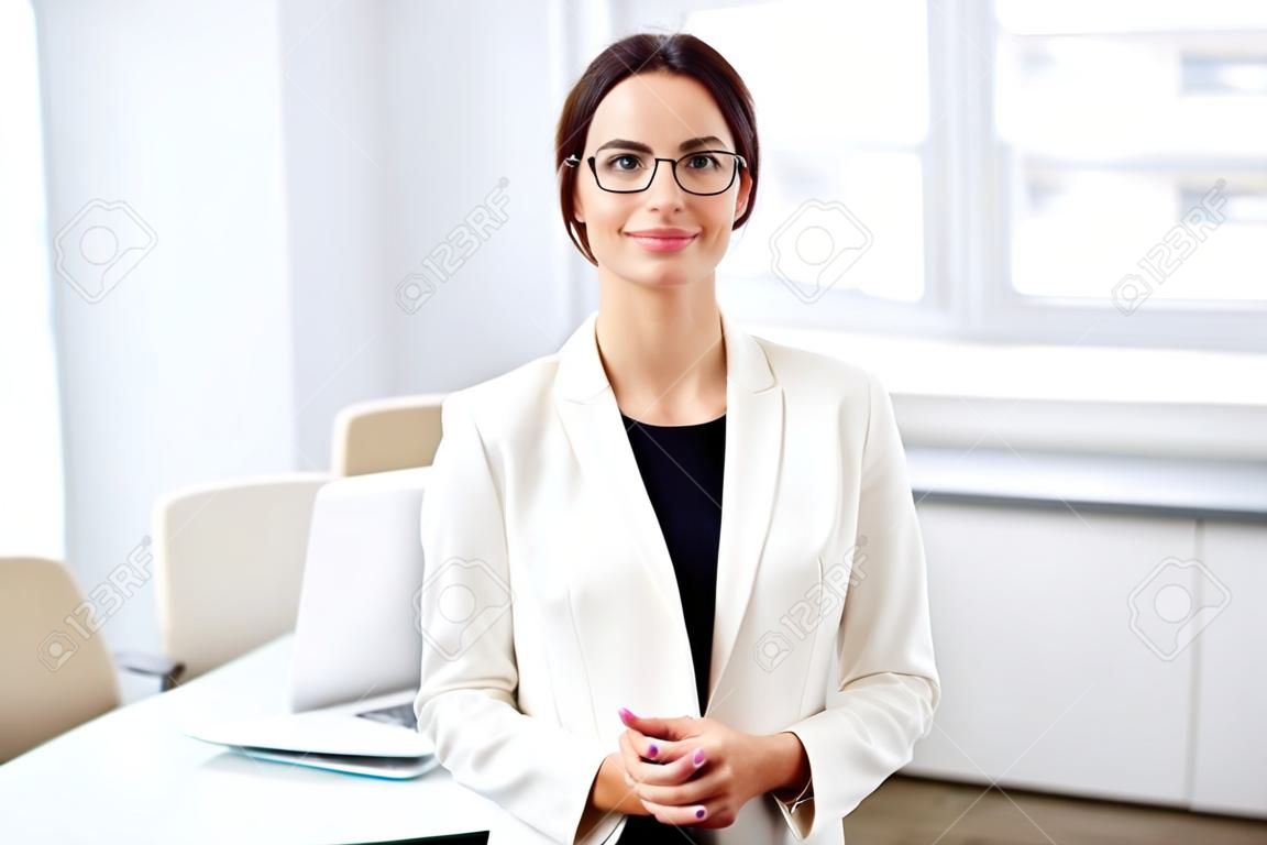 Portrait of a smiling young attractive business woman in an office