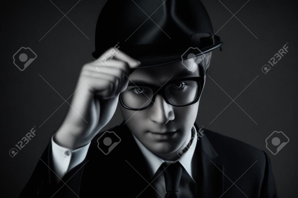 Engineer in black suit on isolated black background