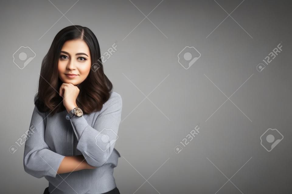 Portrait of a confident woman standing isolated over background