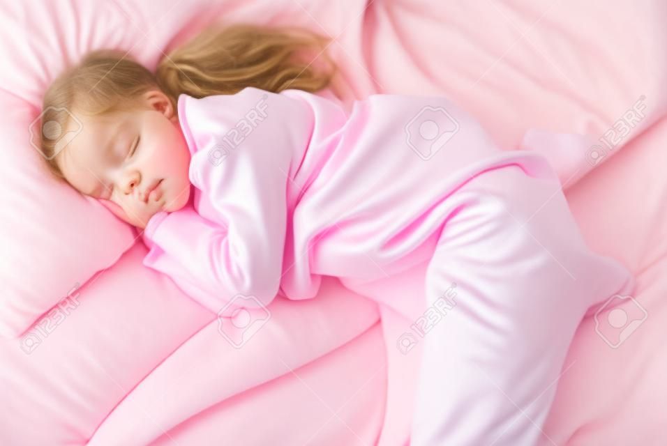 Sleeping beauty. Beautiful girl is weared a pajamas and pink