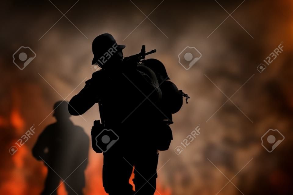 silhouette action soldiers walking hold weapons in jungle