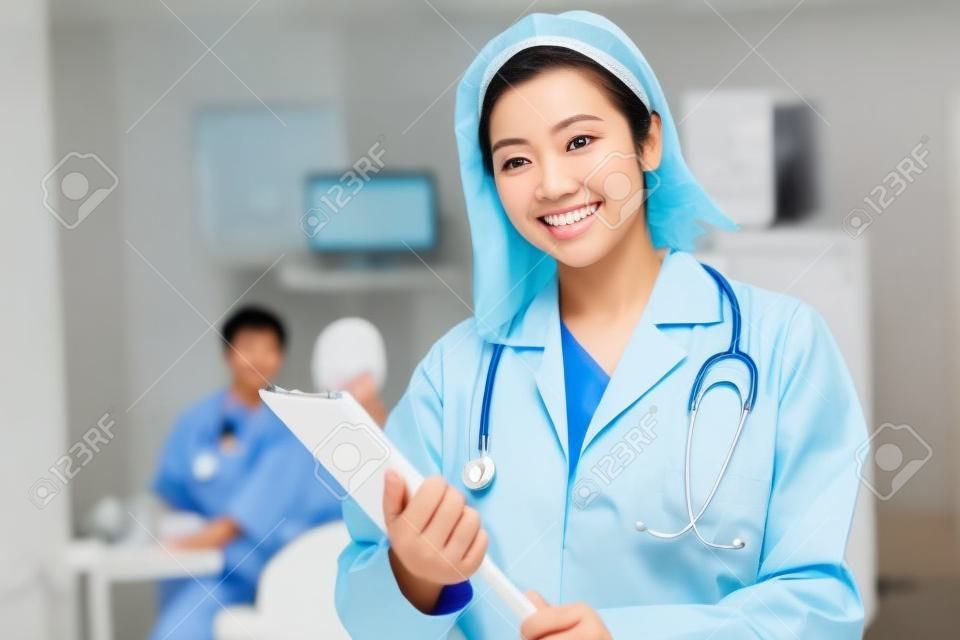 Azjatycka lekarka uśmiechała się przyjaźnie podczas pracy w szpitalu. koncepcje opieki zdrowotnej, chirurgii plastycznej, pielęgnacji urody