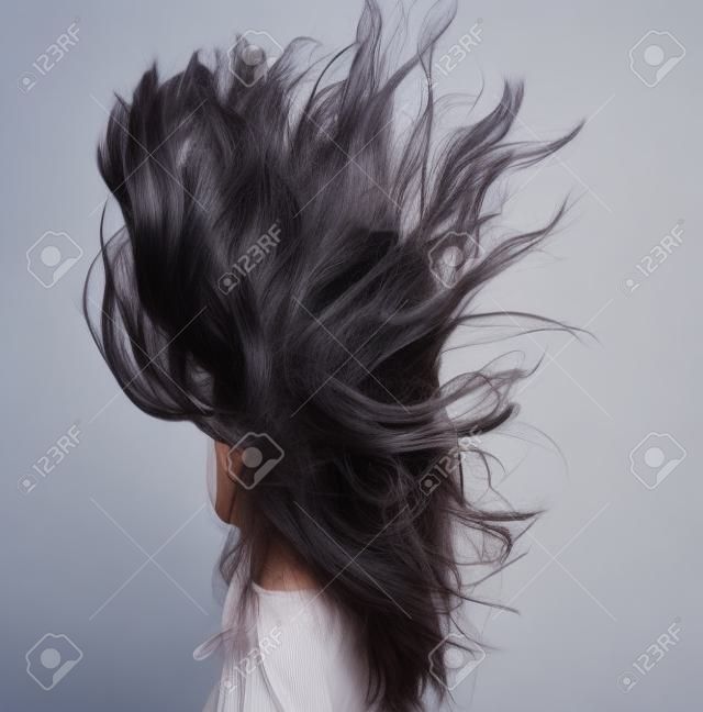 Mode portret van Aziatisch meisje met haar licht uitwaaierende in de wind
