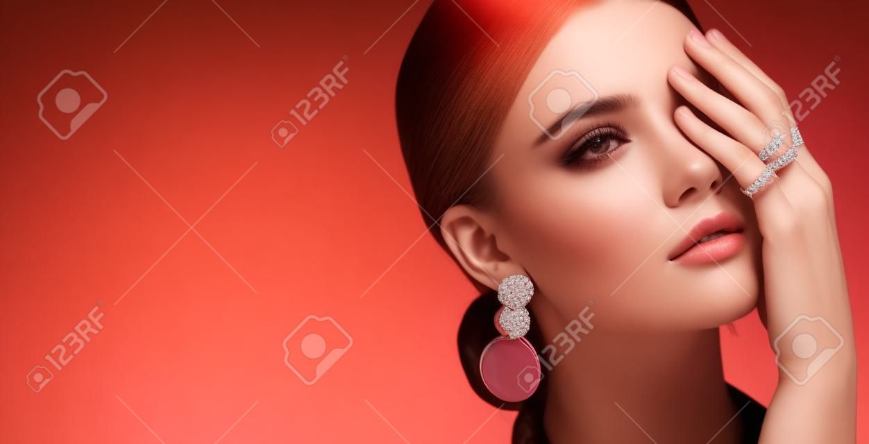 beautiful fashion model wearing elegant jewelry in color light