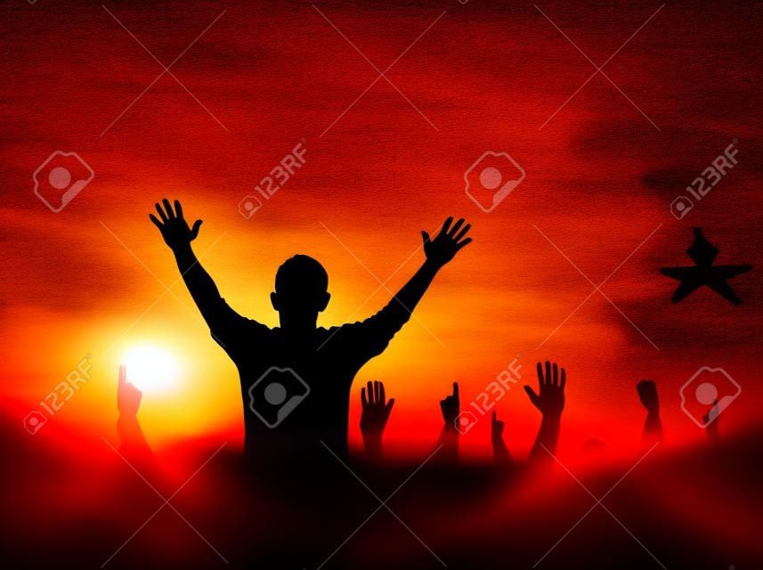 Praise and worship concept: Silhouette human raising hands to praying God on blurred cross with crown of thorn sunset background