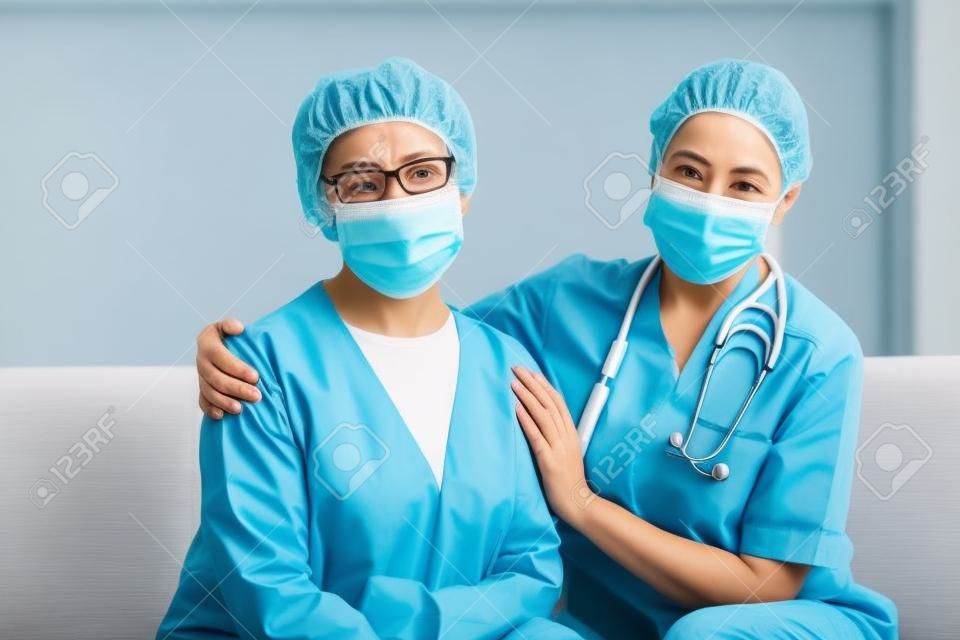 Doctor and senior woman wearing facemasks during coronavirus and flu outbreak. Virus protection. COVID-2019. Taking on masks.