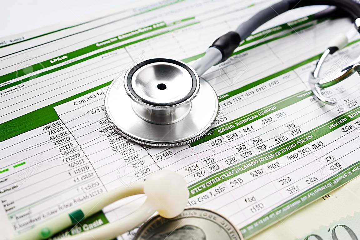 Stethoscope and US dollar banknotes on spreadsheet paper, Financial, account, statistics and business data  medical health concept.