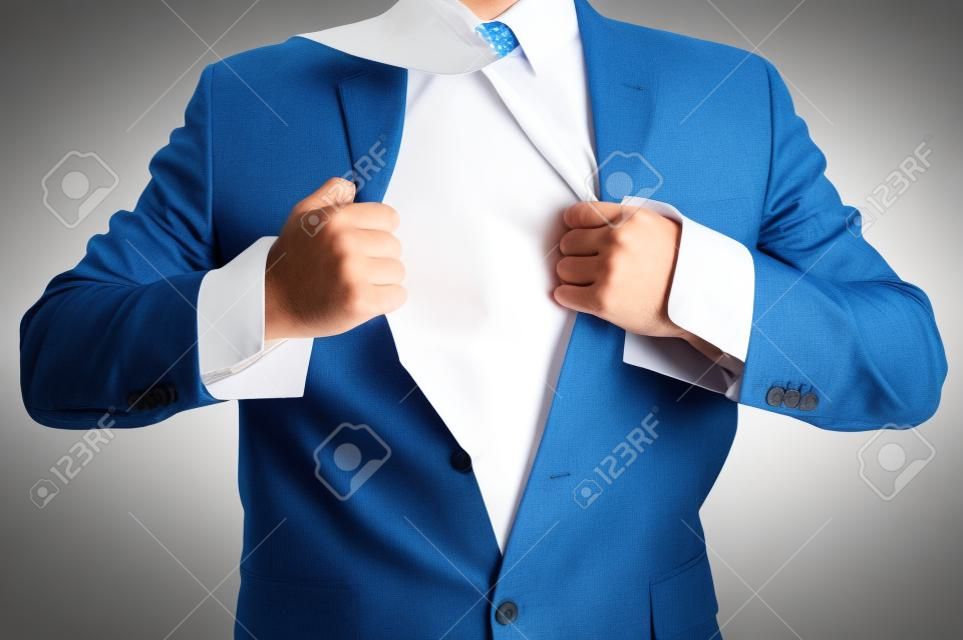 Business man tearing shirt to become a superhero