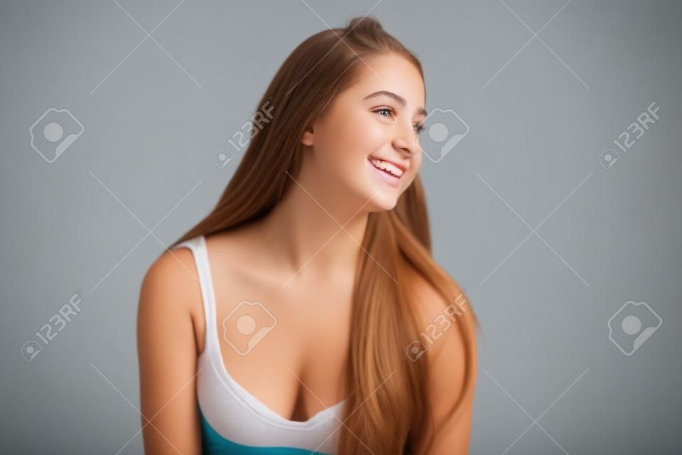 Photo of smiling teenage girl on white background