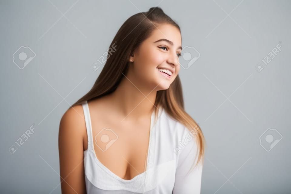 Photo of smiling teenage girl on white background