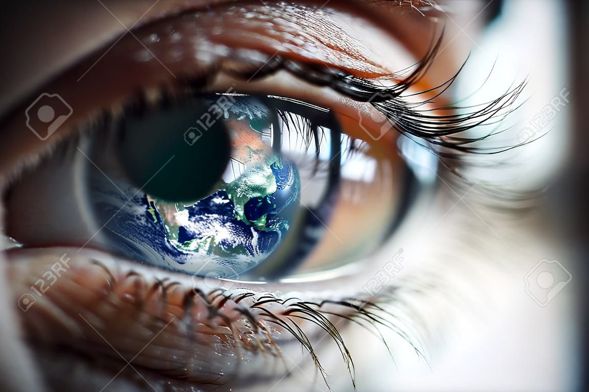 Macro photo of the womans eye and Earth planet