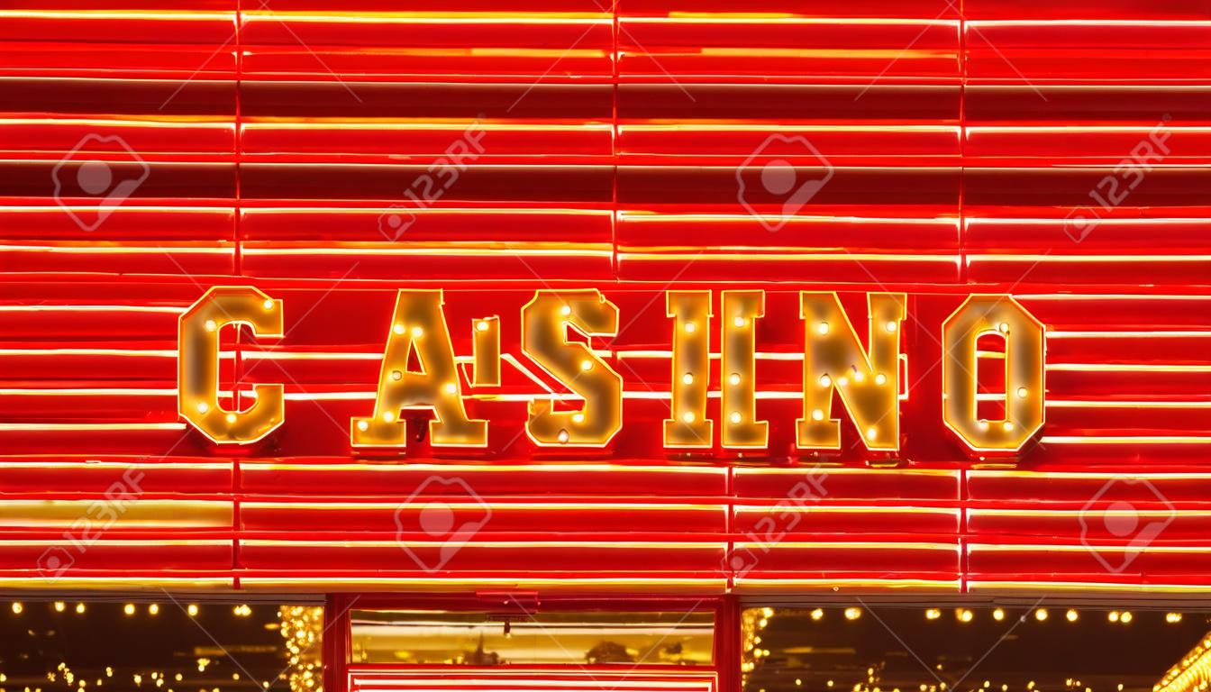 The word casino is lit up in neon lights at night on Fremont Street in Las Vegas