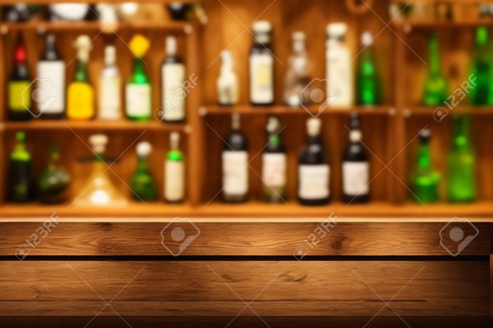 Empty the top of wooden table with blurred counter bar and bottles Background /fFor montage product display