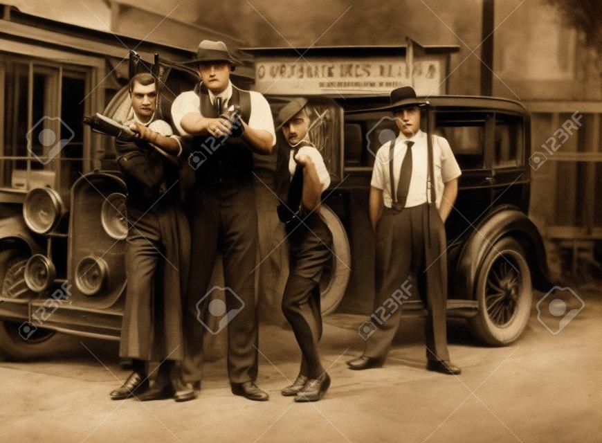 Dangerous 1920s vintage gangsters outside with weapons