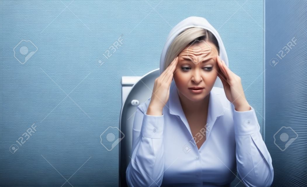 businesswoman in the toilet with problems of constipation