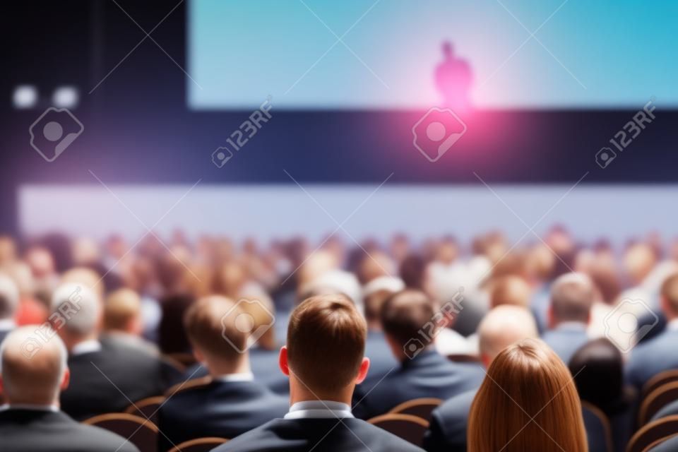 Unrecognizable people listening to speaker during business conference