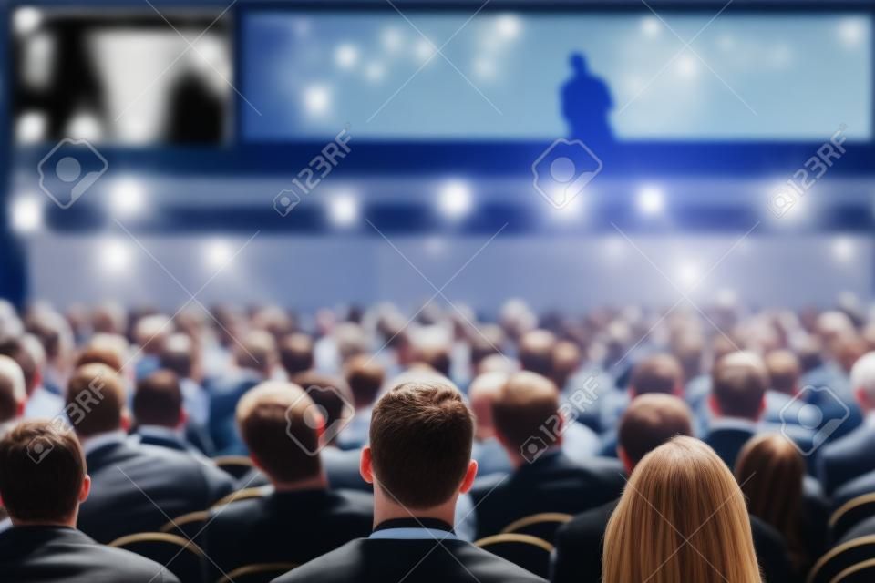 Unrecognizable people listening to speaker during business conference