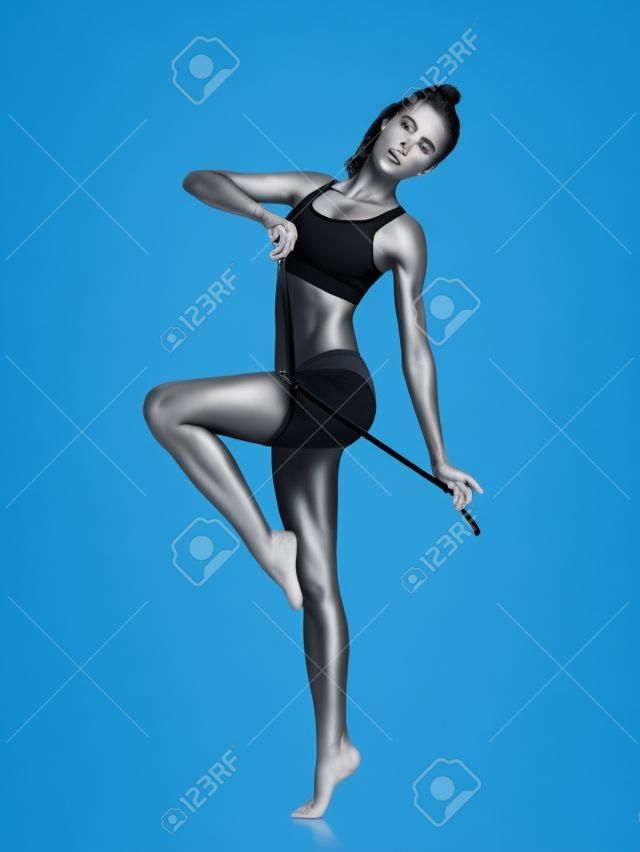 Fitness woman in black sports clothes isolated on white
