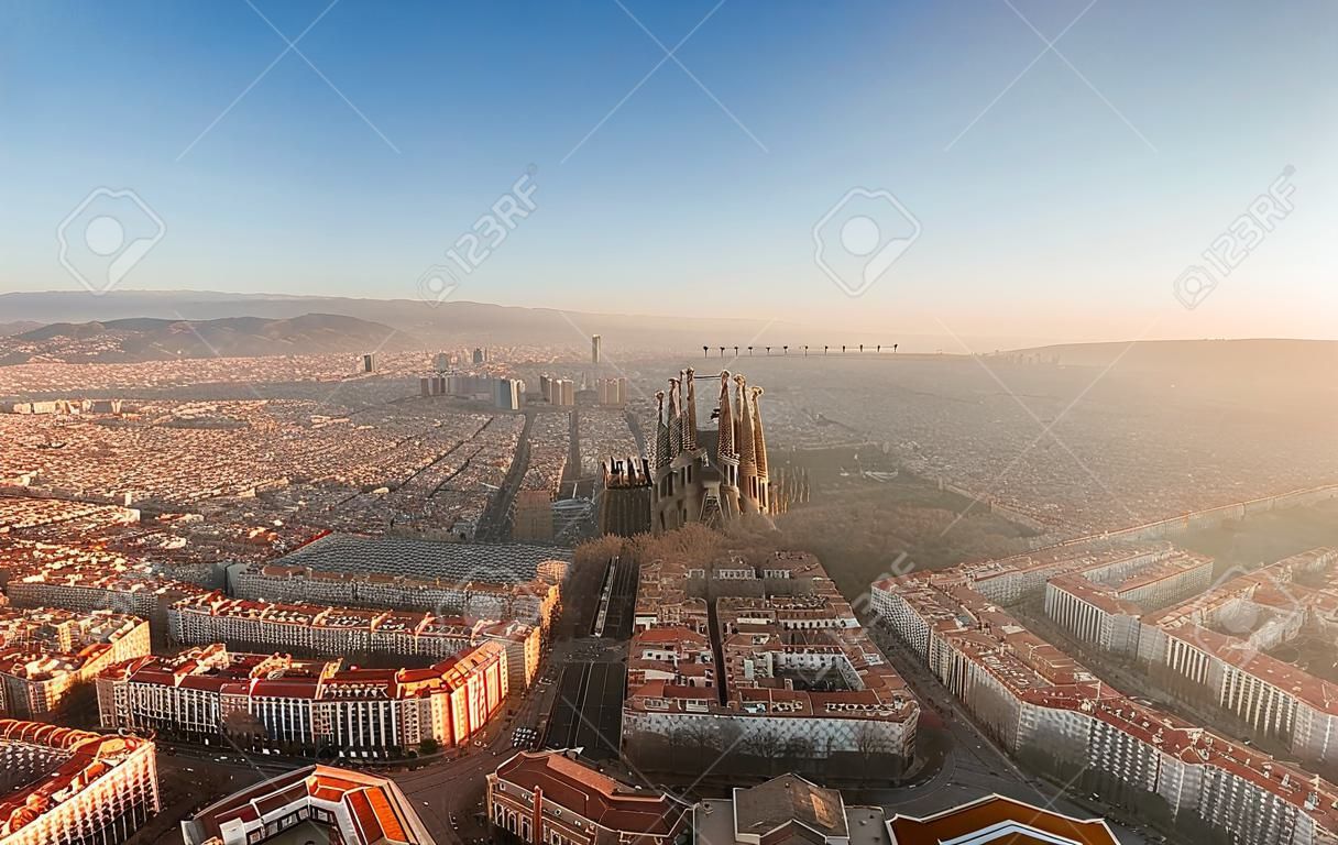 Aerial drone shot of sunrise over Barcelona city center in early morning