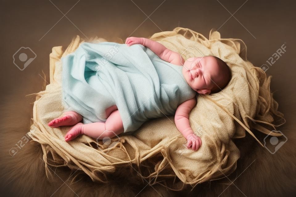 Il bambino Gesù, swaddled e che giace in una mangiatoia