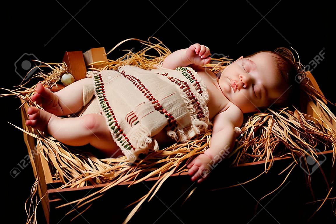 Baby dormido de Jesús en el pesebre