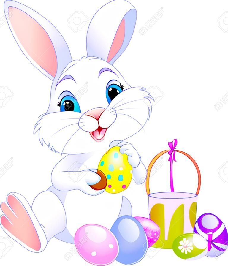Cute Easter Bunny painting an egg