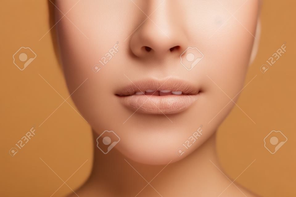 Close up photo of woman's face with perfect skin and lips