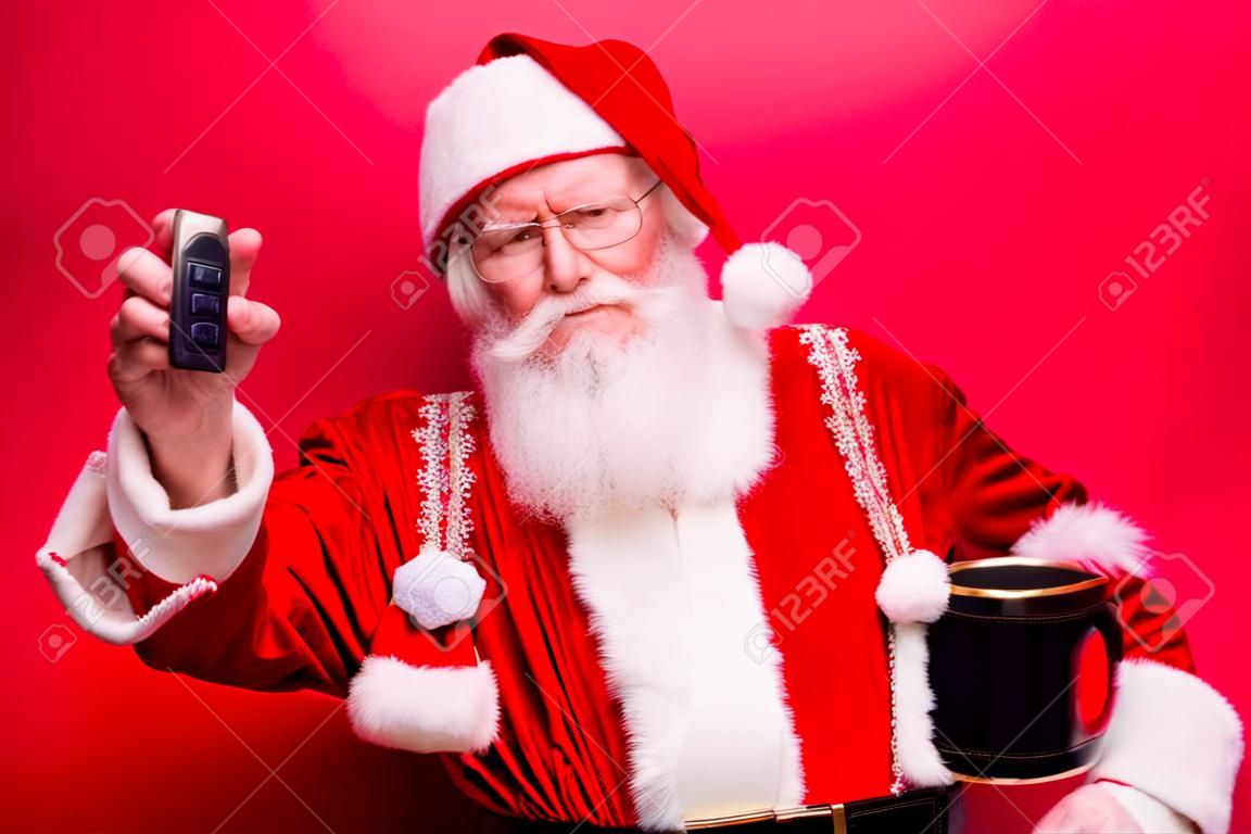 Funny aged grandfather in red traditional outfit and headwear. X mas noel time! Success, happiness, surprise, dream, december, buyer, ownership, property, purchase, rent, sell, cars concept