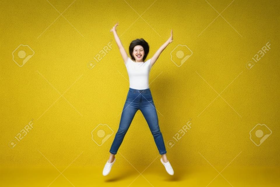 Full length body size photo jumping high beautiful she her lady hands arms separate in star shape figure win wearing casual jeans denim white t-shirt clothes isolated yellow bright vivid background