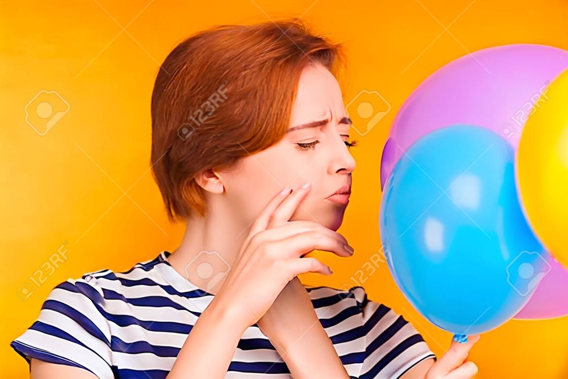 Close-up portrait of nice charming attractive girlish childish lady blowing blue baloon festal event celebratory day preparation tradition isolated over bright vivid shine yellow background