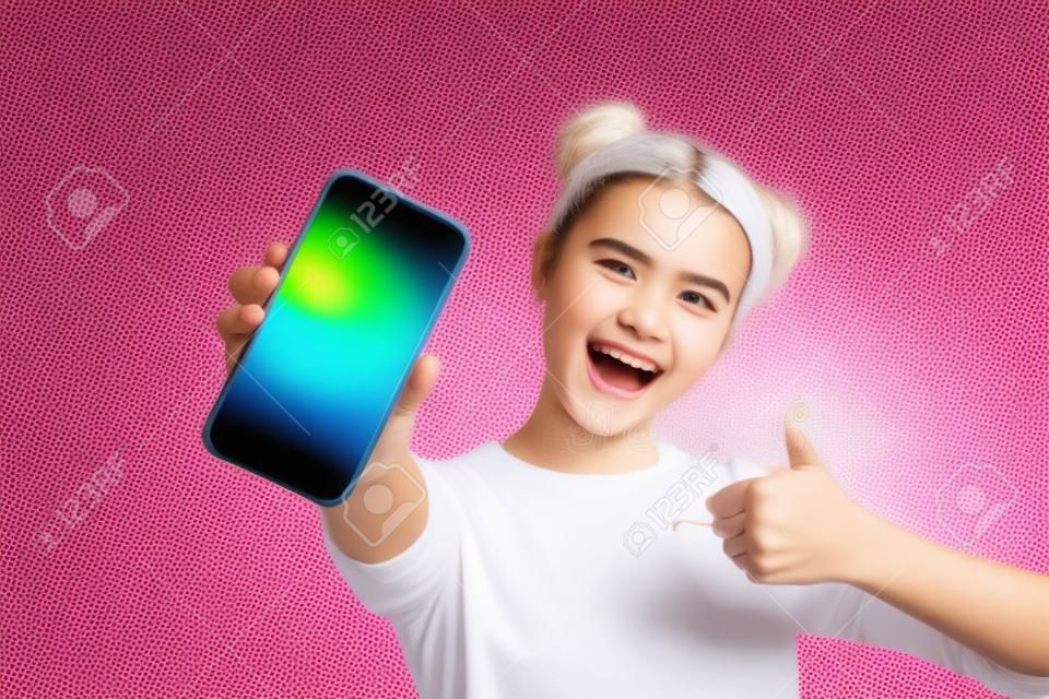 Close up foto van funky energieke student toont haar mobiele telefoon overeenkomst waardering dragen licht katoen outfit op kleurrijke achtergrond